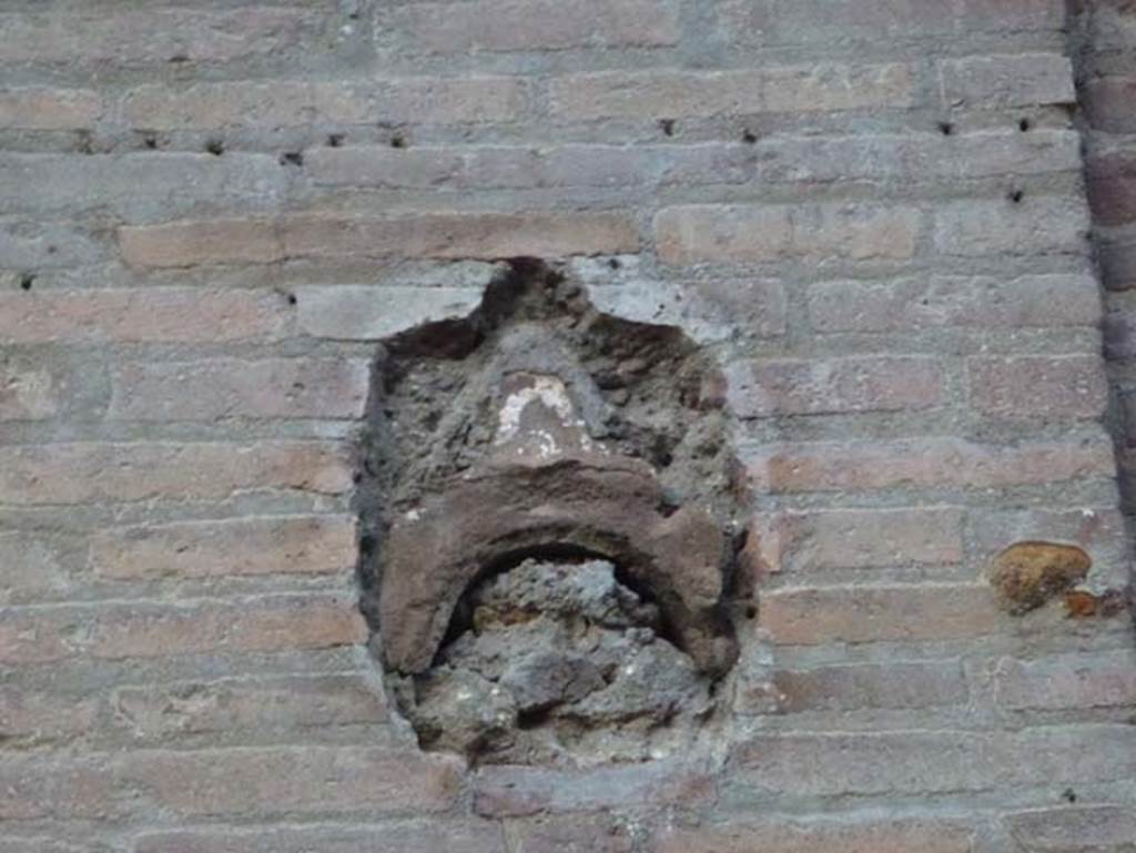 Decumanus Maximus, Herculaneum, October 2012. Detail from pilaster in portico on north side of roadway.  Photo courtesy of Michael Binns.
