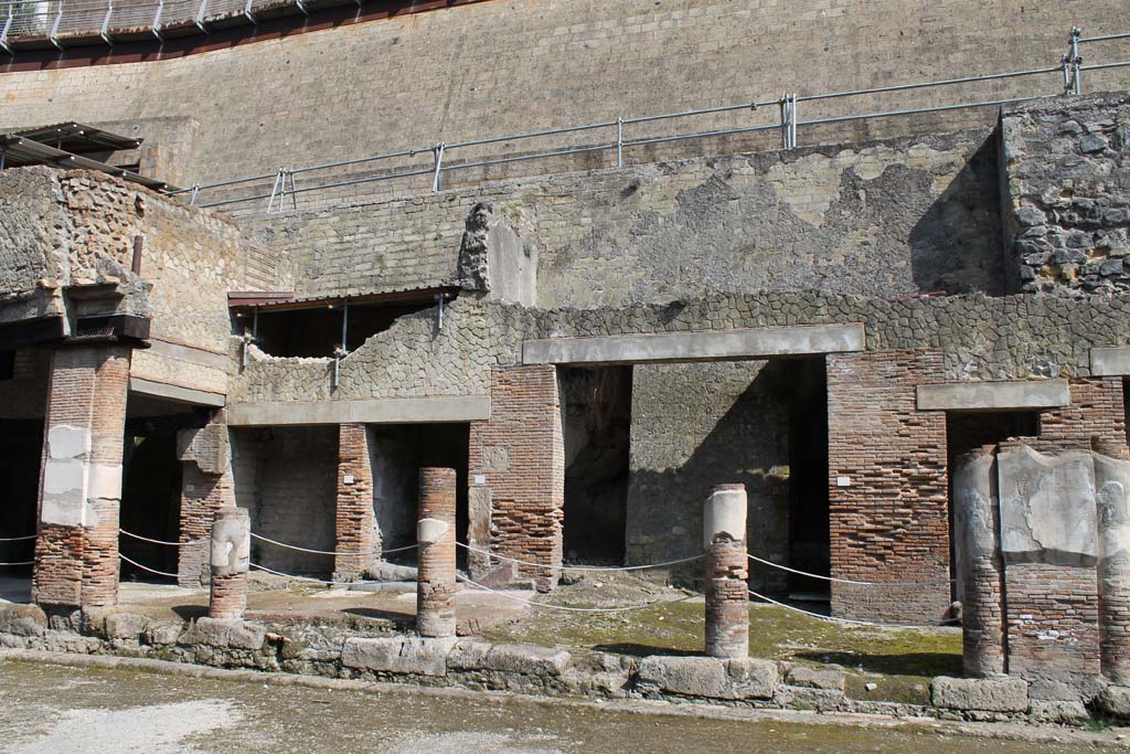 Decumanus Maximus, north side, Herculaneum. March 2014. 
Looking towards doorway 5, on left under colonnade, doorway 6 and 7, and doorway 8 in centre. 
Foto Annette Haug, ERC Grant 681269 DÉCOR.
