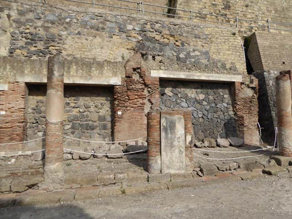 Decumanus Maximus, Herculaneum, October 2014.  Building on north side of the Decumanus Maximus, doorway numbered 10, on left, and number 11, on right.
Photo courtesy of Michael Binns.
