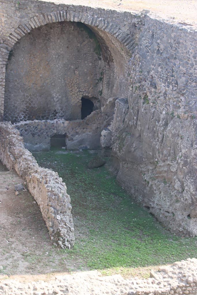 III.1/2/18/19, Herculaneum, October 2023. 
Looking north-east from access roadway across room F, with corridor at rear.
Photo courtesy of Klaus Heese.



