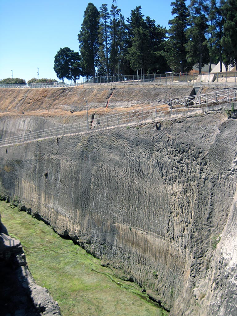 Herculaneum, June 2011. 
Looking east from Ins. III, showing depth of solidified ash still to be excavated below the upper entrance road/ramp. 
Photo courtesy of Sera Baker.
