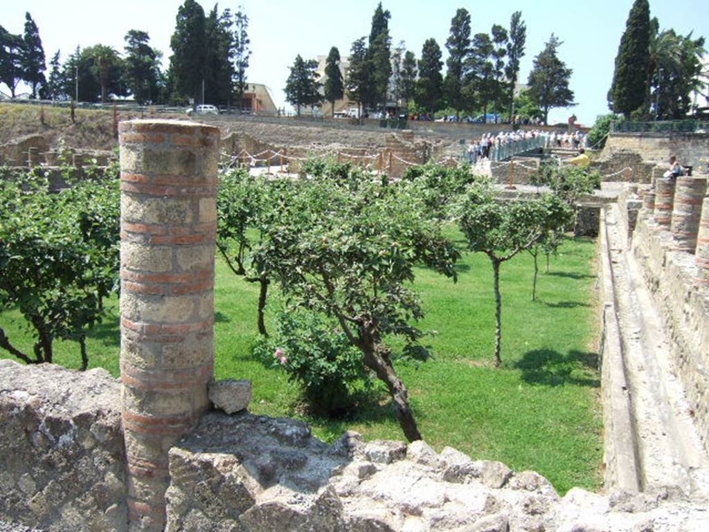 III. 1/2/18/19, Herculaneum. May 2006. Area 31, looking south from west side of large sunken peristyle of III, 1/2/18/19. 
Note - the access bridge to the site used to lead onto the southern rooms and peristyle.

