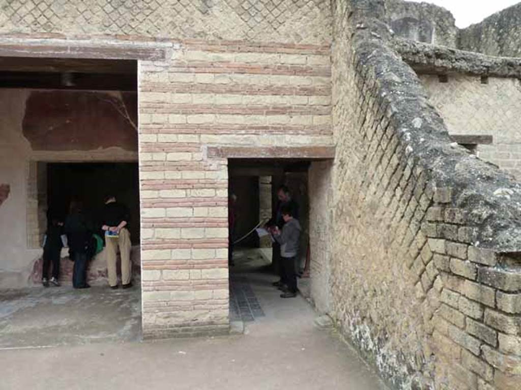 III.3 Herculaneum. May 2010. South-east corner of atrium, with doorway to corridor leading east to triclinium. On the south side of the corridor is a doorway to a room leading to the light-well with smaller nymphaeum. 
