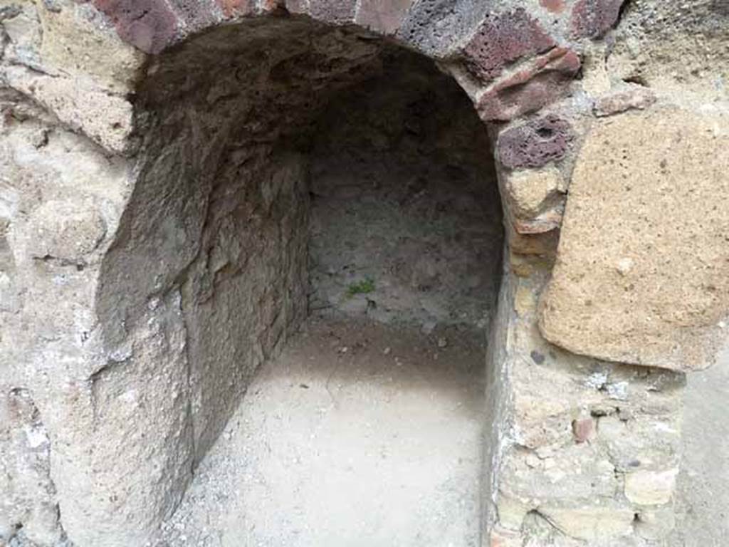 III.4 Herculaneum. May 2010. Smaller arched recess under steps to upper floor at III.5.