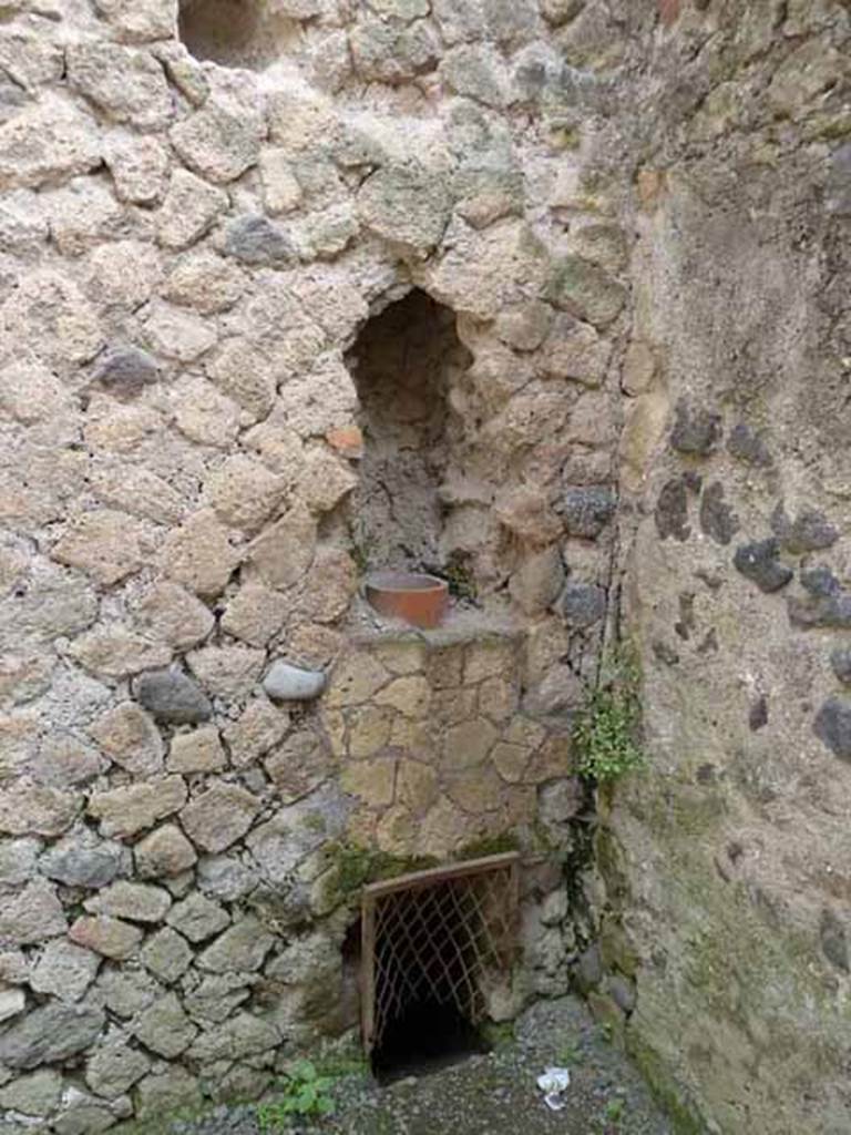 III.4 Herculaneum. May 2010. Down-pipe in wall in south-east corner of second room.