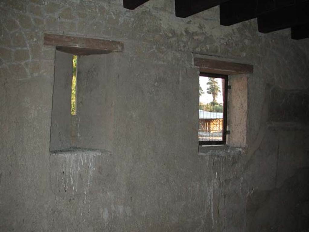 III.10, Herculaneum. September 2003.  
Looking towards east wall with windows, of room positioned above the cubiculum and entrance corridor of the Casa del Tramezzo di legno 
Photo courtesy of Nicolas Monteix.
