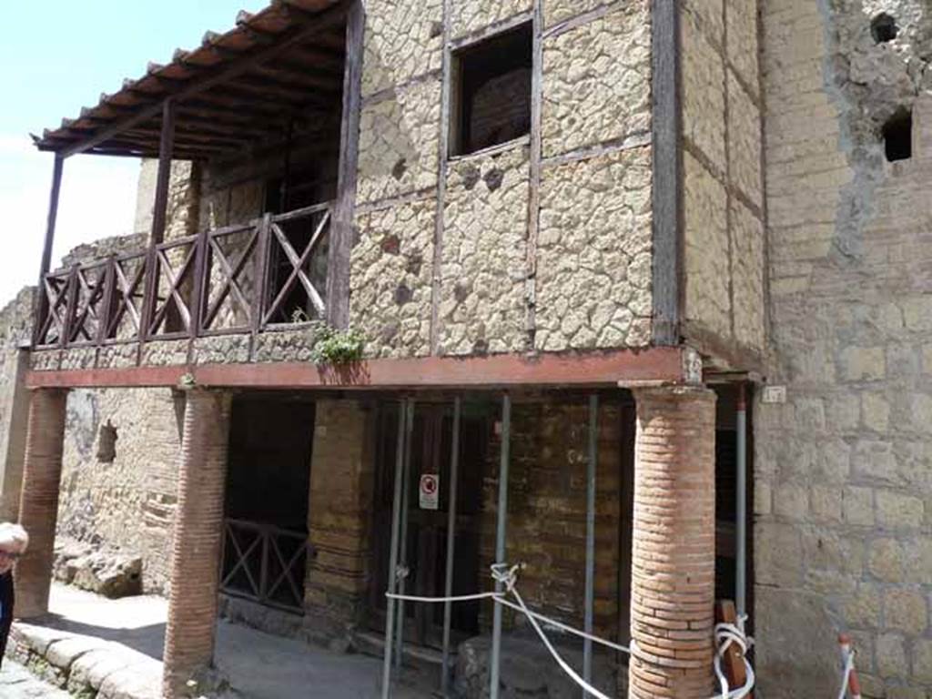 Ins. III.15, 14, and 13 (behind right column). May 2010. Entrance doorways, and restored upper balcony.