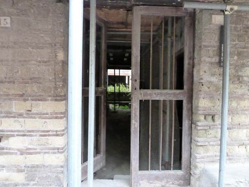 Ins. III 14, Herculaneum, May 2015. Looking west through entrance doorway towards a small courtyard.