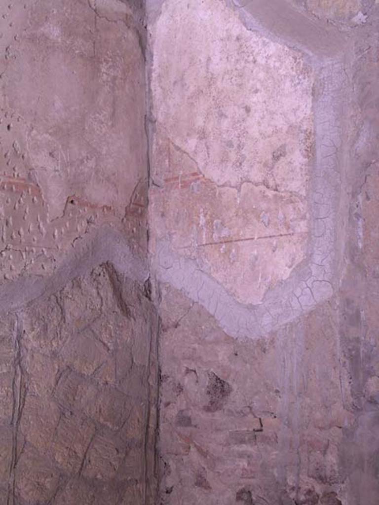 III 15, Herculaneum, May 2005. 
Looking towards painted decoration on south end of west wall of shop room.
Photo courtesy of Nicolas Monteix.
