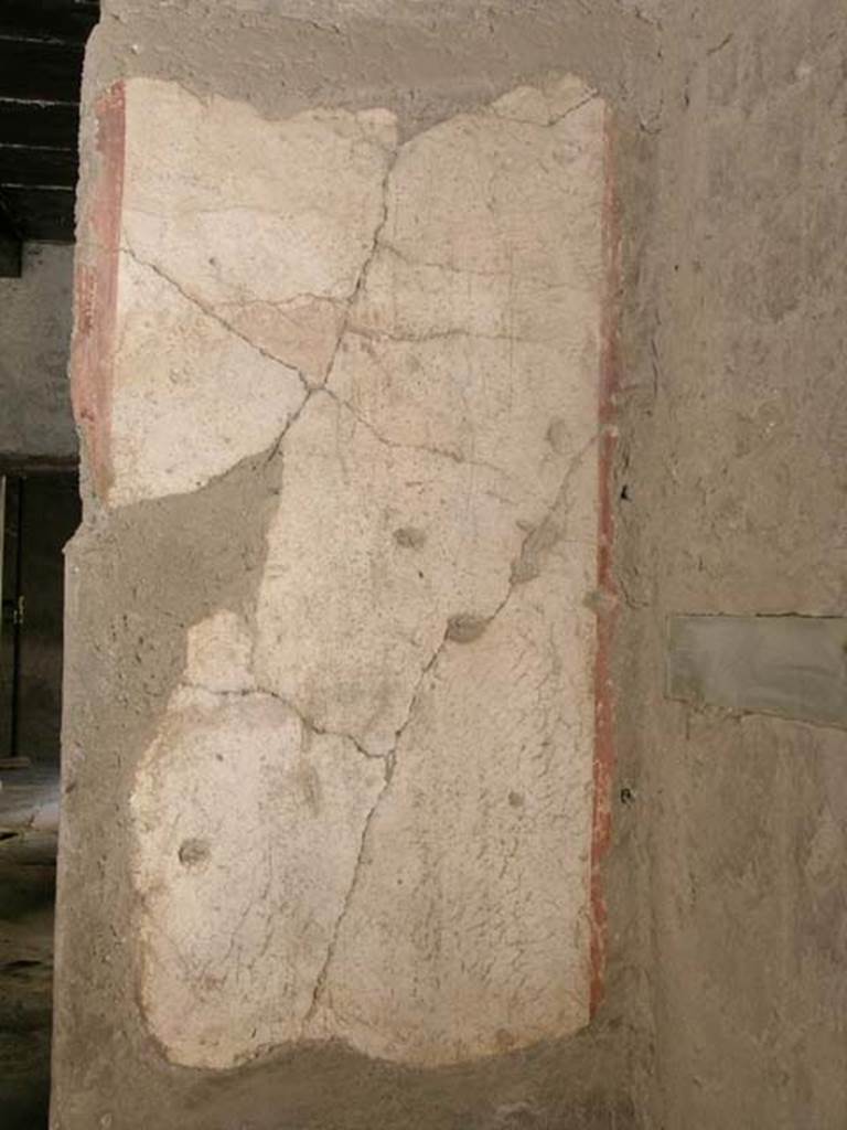 III 15, Herculaneum, May 2005.
North end of west wall of shop-room, with opening to rear room, on left.
Photo courtesy of Nicolas Monteix.
