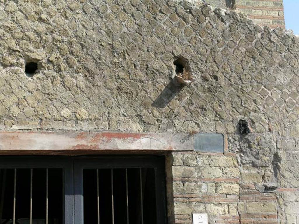 IV.2, Herculaneum, June 2005. Detail of façade above entrance doorway. Photo courtesy of Nicolas Monteix.