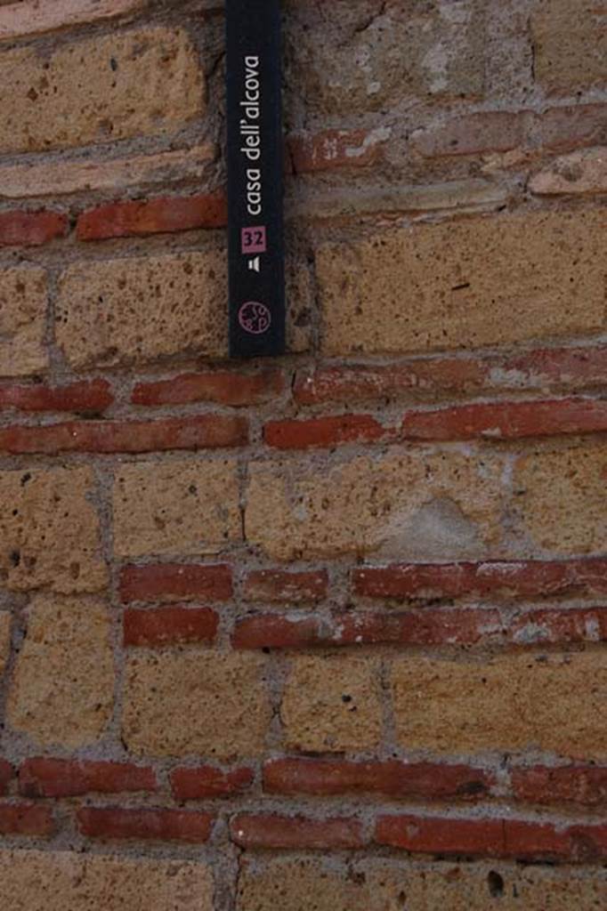 IV.4 Herculaneum. May 2011. House name-plaque with detail of brickwork. 
Photo courtesy of Nicolas Monteix.
