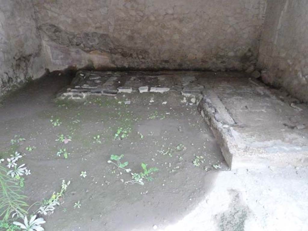 IV.4 Herculaneum. September 2015. Room 19, looking west towards the remains of the two-sided carbonised wooden couch, still partly buried in the volcanic debris/mud.
