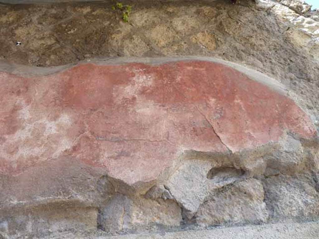 Ins. IV.8, Herculaneum, May 2010.  Detail of painted decoration above doorway. 

