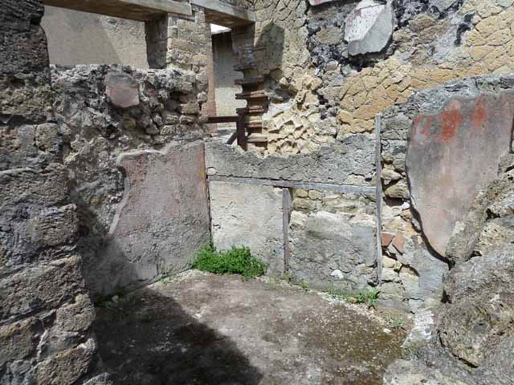 Ins. IV.8, Herculaneum, May 2010. Room on north side of entrance doorway.
Ion the centre of the photo is the doorway at IV.9 which would have been stairs leading to an upper floor. 
