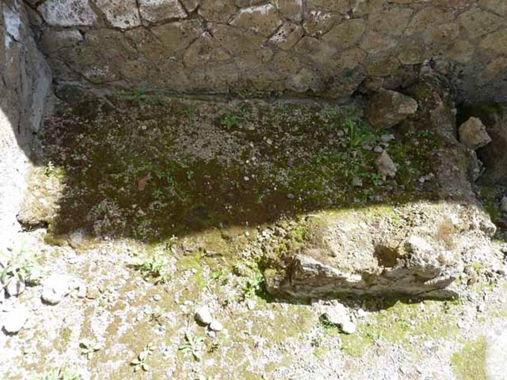 Ins. IV.8, Herculaneum, May 2010. Structure, perhaps hearth or bench, against east wall. 