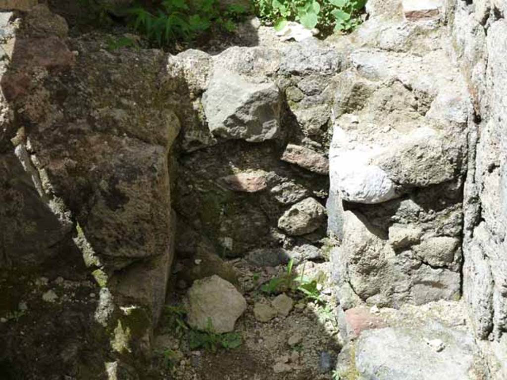 Ins. IV.8, Herculaneum, May 2010. Looking west towards latrine.  