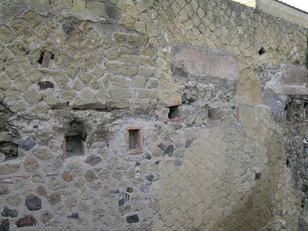 IV.13 Herculaneum, May 2005. 
Looking towards upper west wall above room 2, with some remaining wall plaster. 
Showing the holes for the support beams to support the upper floor. Photo courtesy of Nicolas Monteix.
