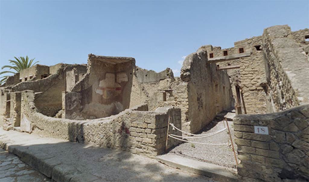 Herculaneum IV.18, May 2004. Entrance doorway to dwelling. Looking west from entrance along corridor.  The small doorway om the left is to room 1.
The room to the left with the painted wall and triangular roof portion is room 2 of IV.19.

