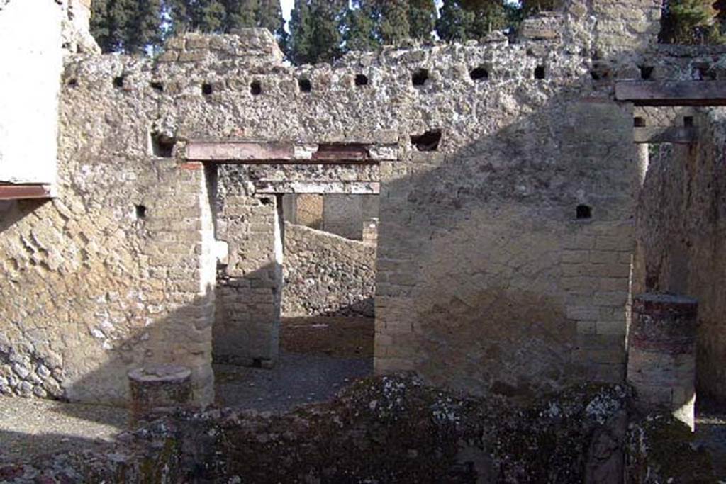 IV.18, Herculaneum, April 2002. Room 11, looking east across the tetrastyle atrium closed by a pluteus or parapet.
The doorway to the vestibule/anteroom of the triclinium is centre left, looking through into the triclinium. The entrance corridor is on the right.  Photo courtesy of Nicolas Monteix.
