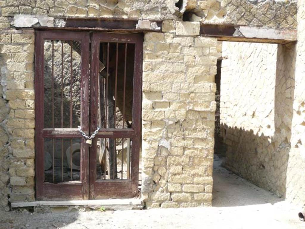 IV.19 Herculaneum. August 2013. Doorway to rear room 3, on left, where widths of cloth were found, and corridor to rear. Photo courtesy of Buzz Ferebee.
