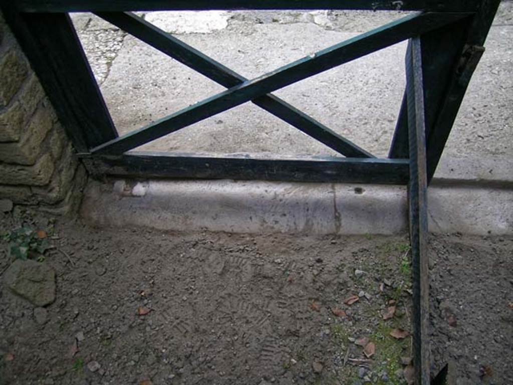 V.3, Herculaneum, May 2005. Looking west from interior across threshold at south end, outside to Cardo IV. Photo courtesy of Nicolas Monteix.
