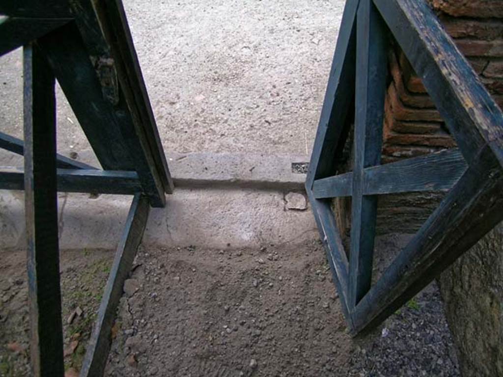 V.3, Herculaneum, May 2005. Looking west from interior across threshold at north end, outside to Cardo IV. Photo courtesy of Nicolas Monteix.
