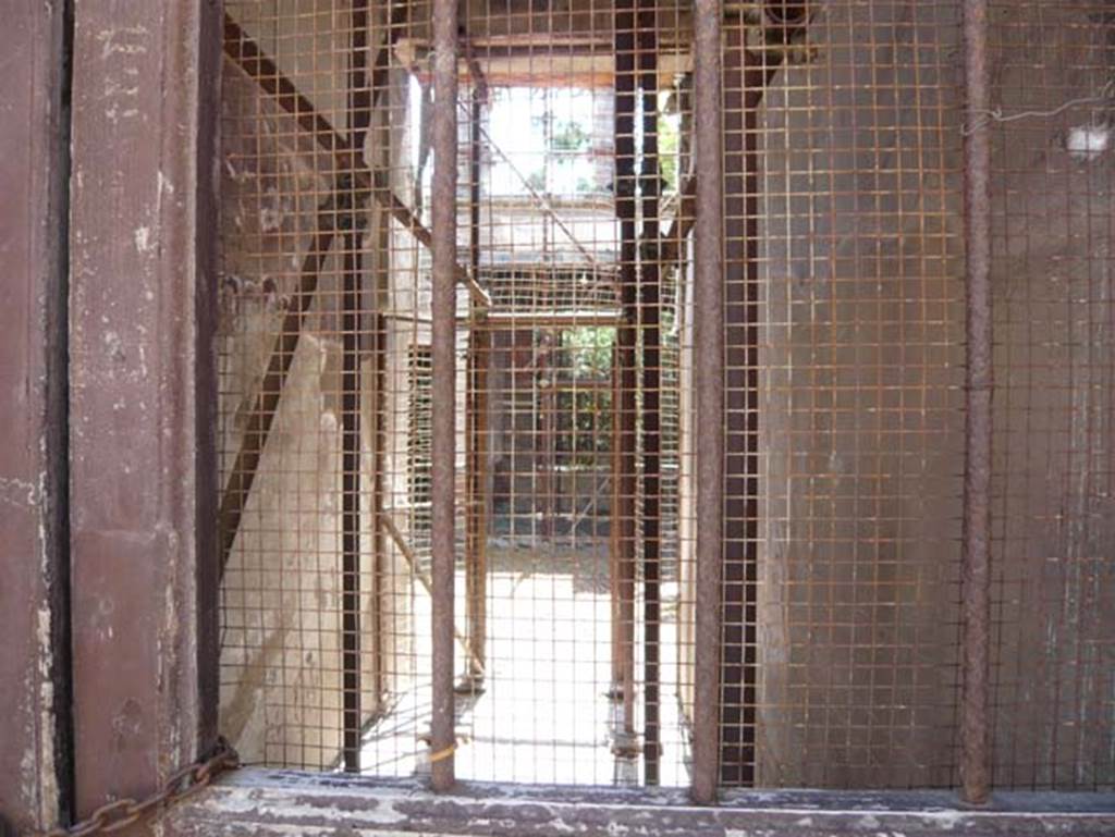 V.5 Herculaneum. August 2013. Looking east through entrance doorway, during restoration. Photo courtesy of Buzz Ferebee.
