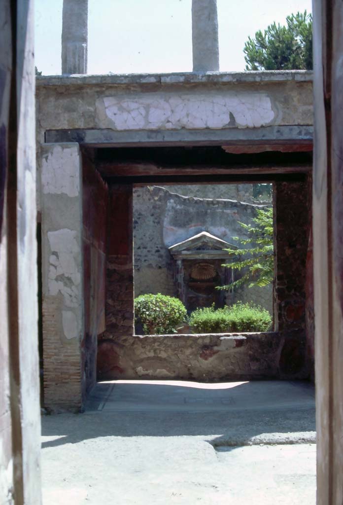 V.5 Herculaneum, 7th August 1976. Looking east from entrance corridor across atrium towards tablinum.
Photo courtesy of Rick Bauer, from Dr George Fay’s slides collection.
