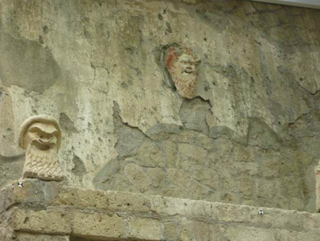 V.7, Herculaneum. August 2013. May 2009. North wall of internal courtyard with theatrical masks.  Photo courtesy of Buzz Ferebee.
