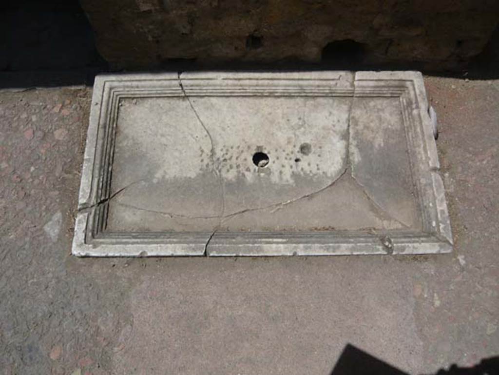 V.7 Herculaneum. August 2013. Marble base of fountain in atrium near south wall.
Photo courtesy of Buzz Ferebee.

