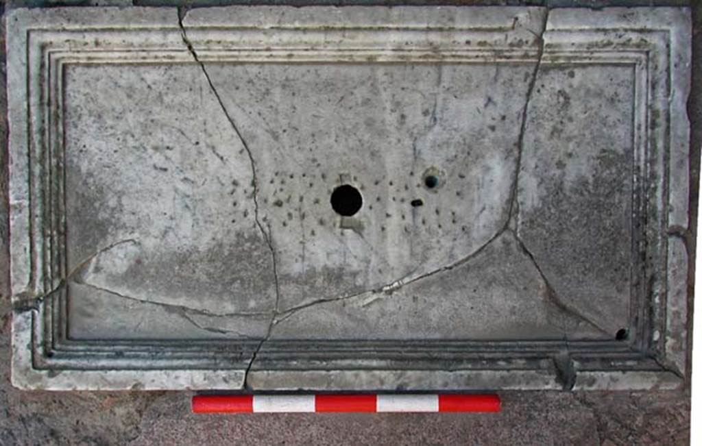 V.7 Herculaneum. September 2003. Marble base of fountain in atrium near south wall.
Photo courtesy of Nicolas Monteix.

