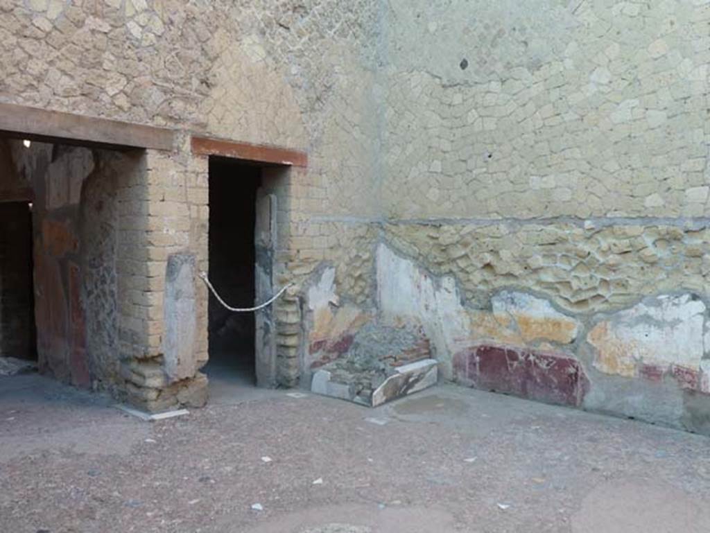 Ins. V 7, Herculaneum, September 2015. Looking towards north-west corner of atrium, with remains of lararium.