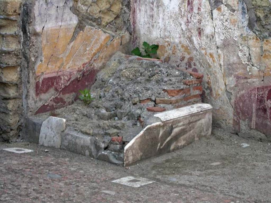 V.7, Herculaneum. June 2002. Atrium, looking towards remains of lararium in north-west corner.  
Photo courtesy of Nicolas Monteix.
