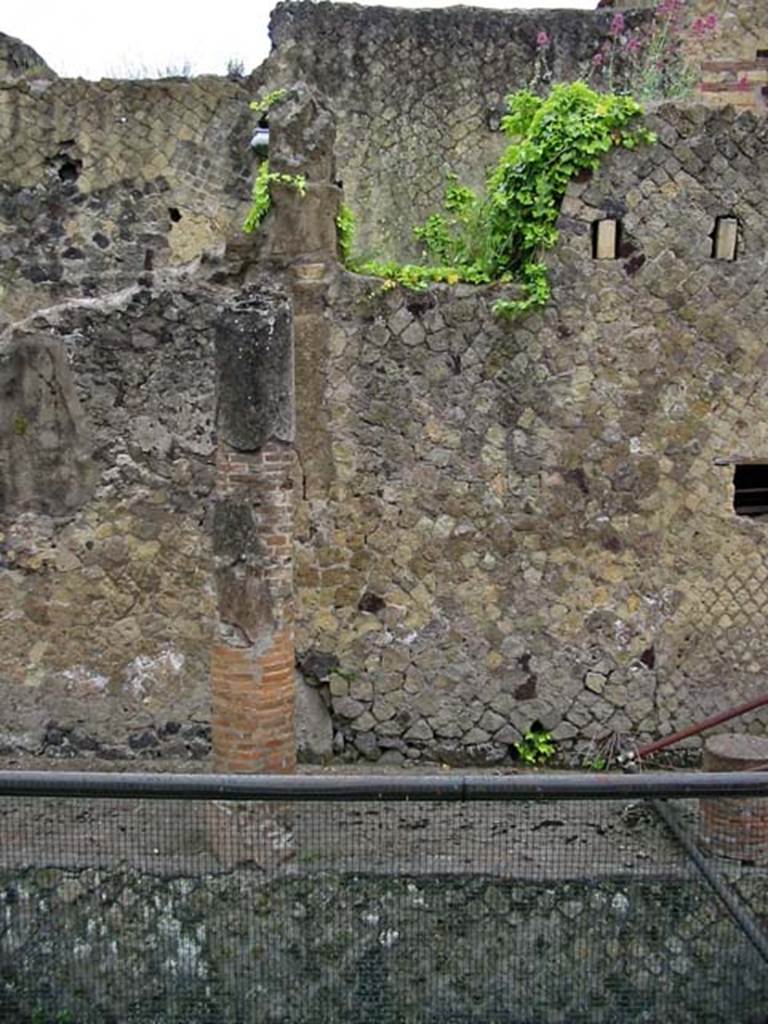 V.11/8, Herculaneum. May 2003. Looking east to front facade.
On the left is the southern boundary of V.11, on the right with holes for the support beams of an upper floor, is part of V.8
Photo courtesy of Nicolas Monteix.
