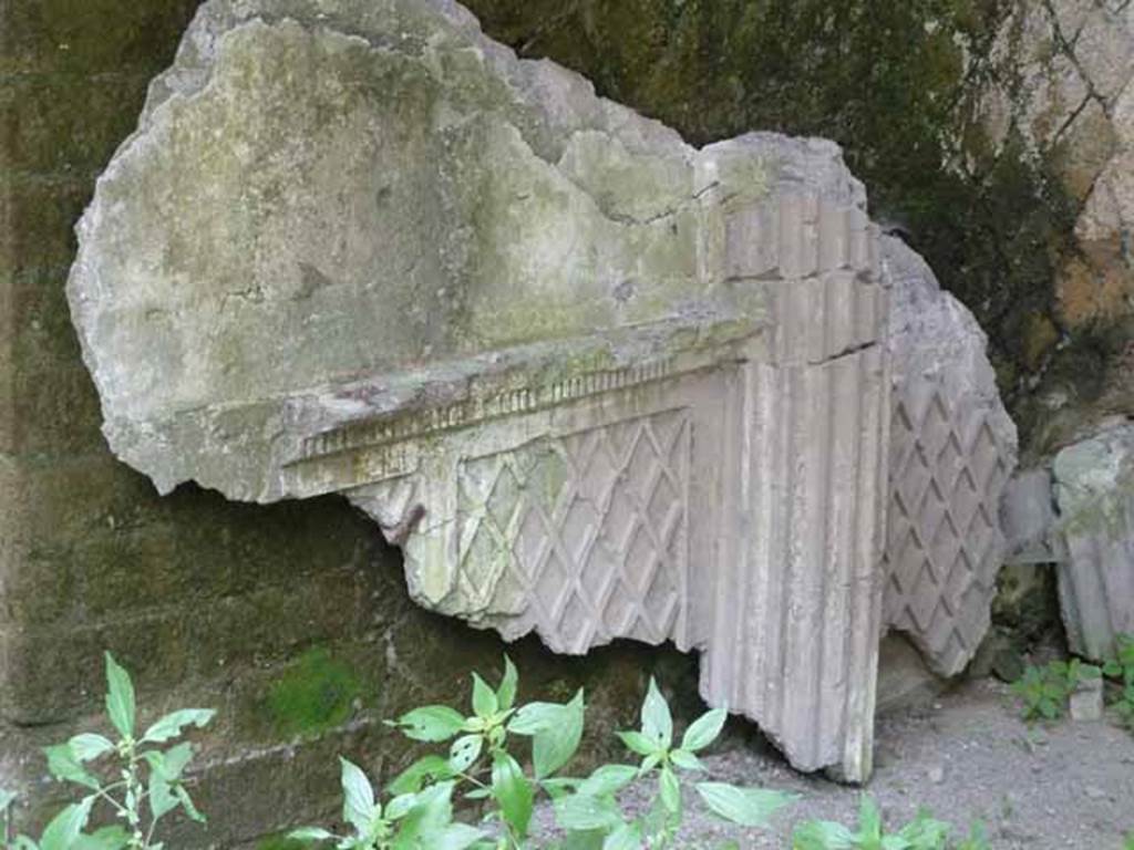 V 13, Herculaneum. May 2010. Detail of stucco remains against east wall. 