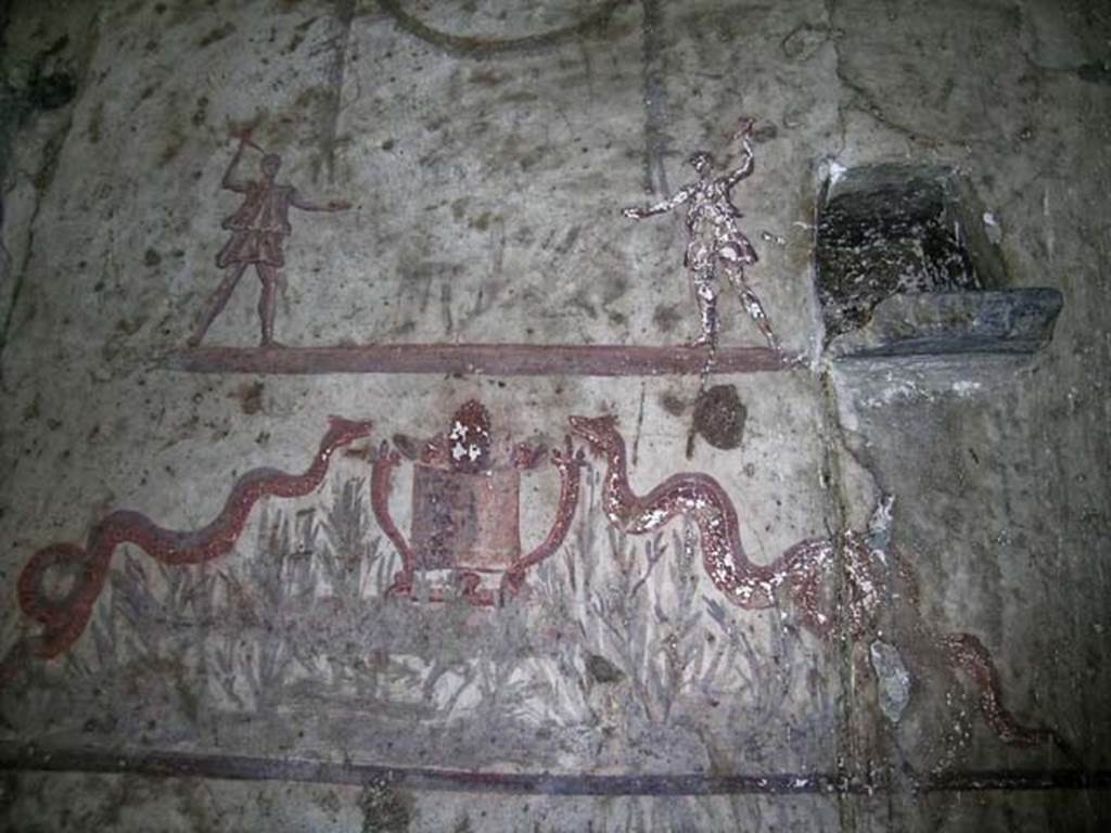 V.14, Herculaneum. May 2004. Detail of lararium on south wall of apartment. 
Photo courtesy of Nicolas Monteix.
