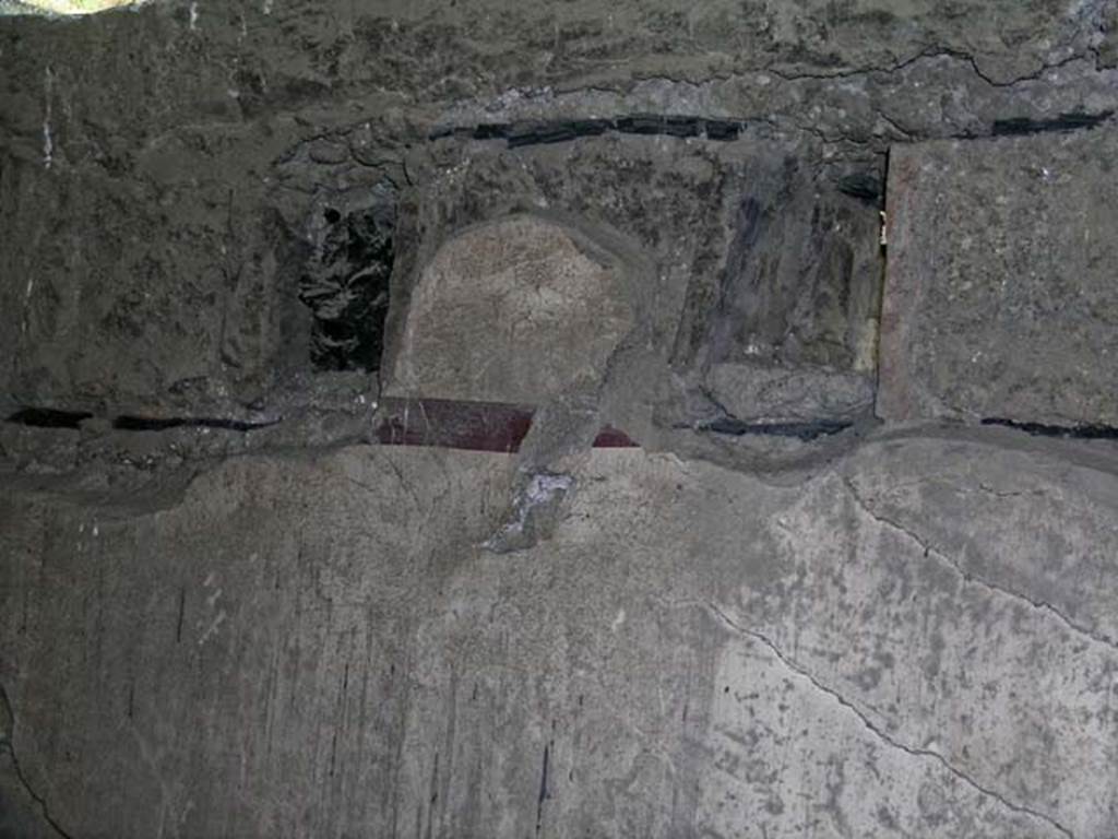 V.17, Herculaneum. May 2004. Detail of area of support beams on north wall, above doorway.
Photo courtesy of Nicolas Monteix.
