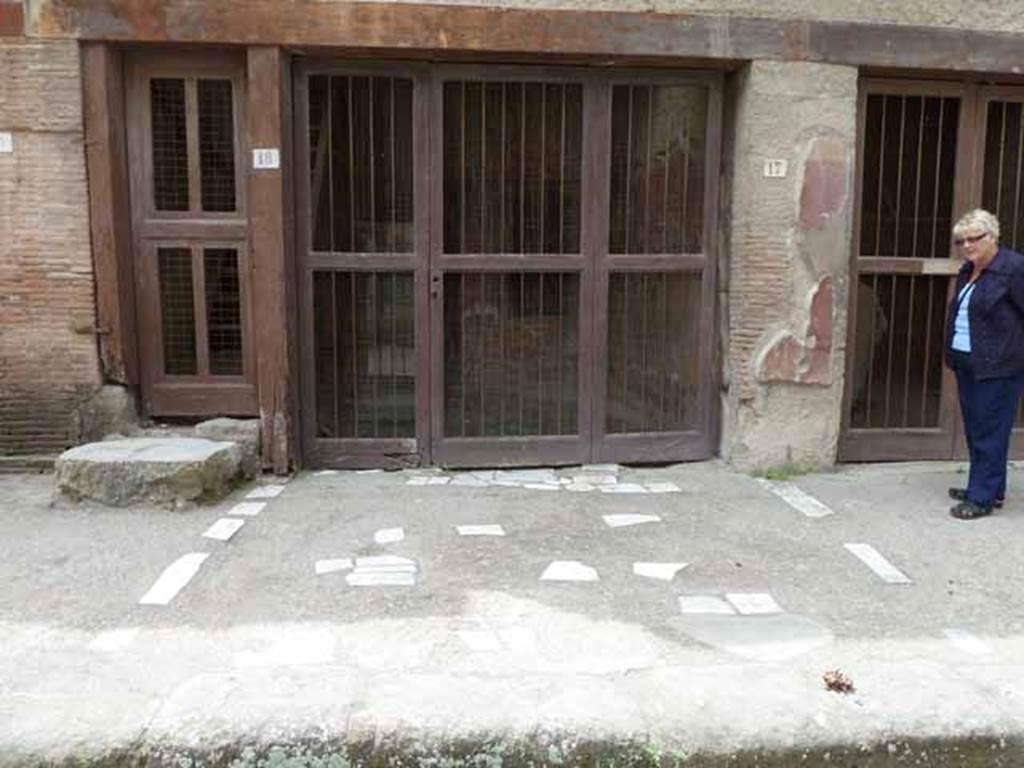 V 18, Herculaneum, May 2010. Small doorway giving access to stairs to upper floor, and V 17, centre, and V.16, on right.  
