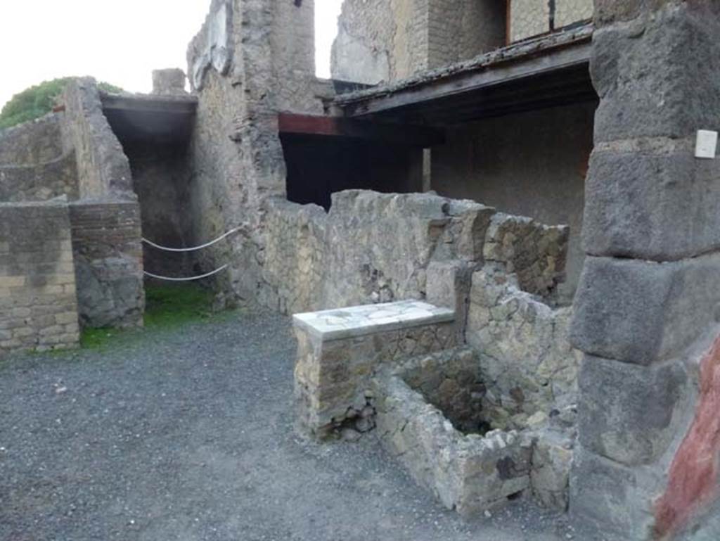 V 21, Herculaneum, October 2012. Looking south along west wall of shop-room with counter. Photo courtesy of Michael Binns.
