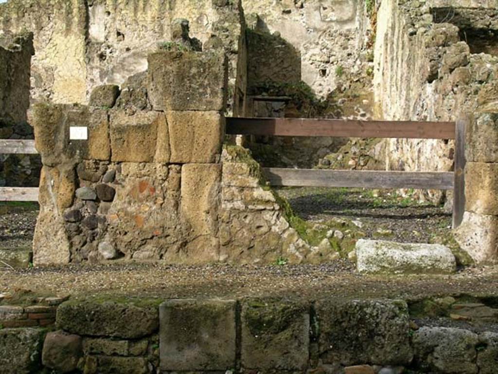 V.26, Herculaneum. December 2004. Facade and pavement on south side of entrance doorway. 
Photo courtesy of Nicolas Monteix.
