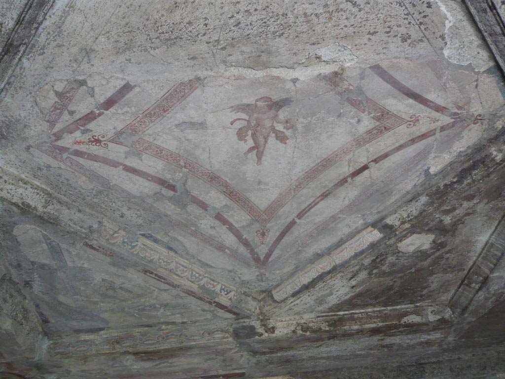 V.30 Herculaneum. August 2013. Room 7, cherub on central flat part of painted ceiling. Photo courtesy of Buzz Ferebee.