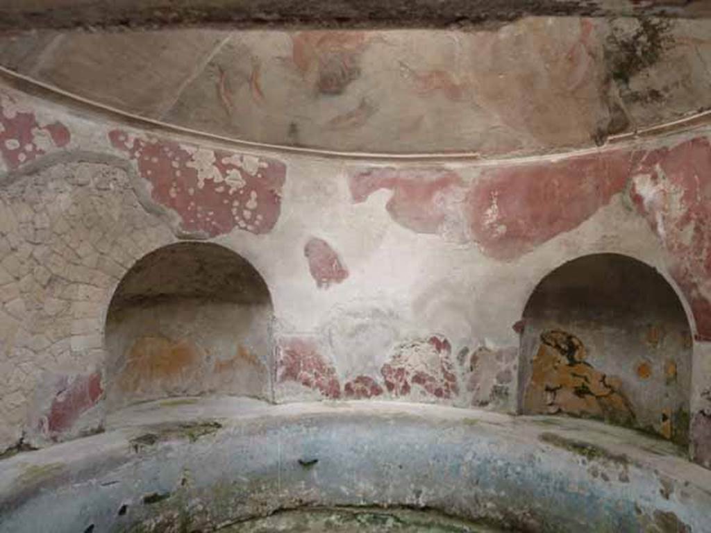 VI.1/7, Herculaneum. May 2010. Looking south towards two of the four niches set around the pool.
The walls were red, and the walls of the niches were golden yellow.
