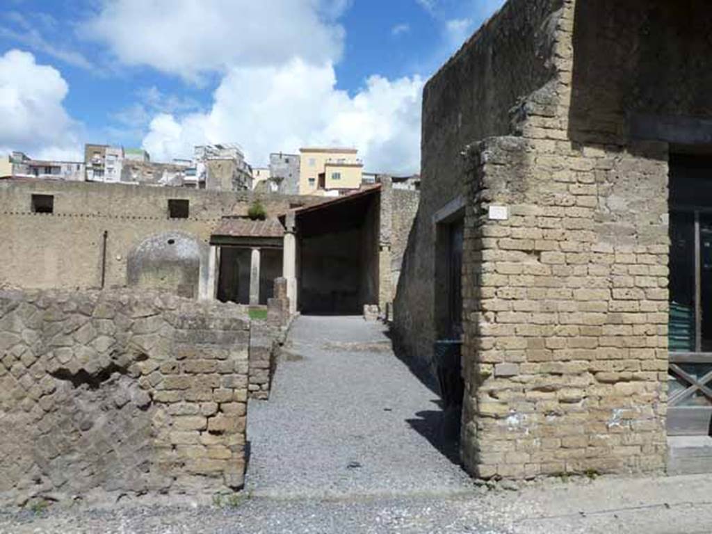 Ins. VI.5. May 2010. Looking north on Decumanus Inferiore, towards doorway leading to open-exercise area. 