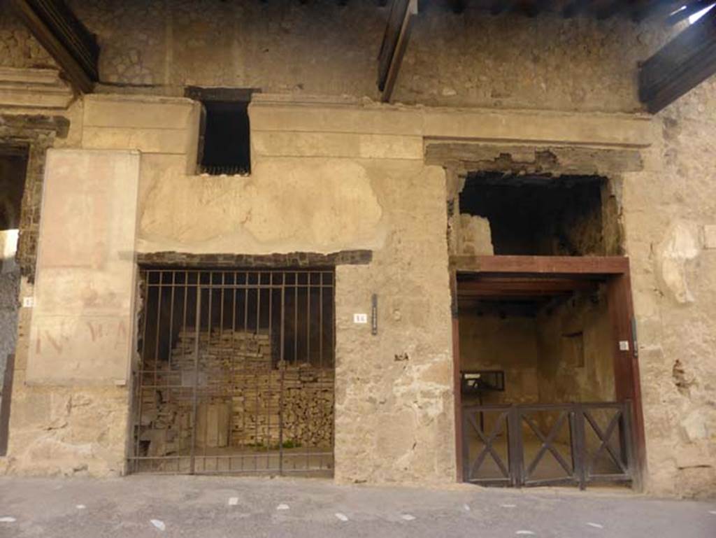 Ins. VI 14 and 15, Herculaneum, September 2015. The pilaster on the left of the entrance doorway showed the painted sign with four pitchers of different coloured liquids, the drinks sold here and a list of their prices. At the top was a painted figure, and the panel at the bottom has an inscription painted in red reading NOLA, an announcement of a forthcoming gladiator’s show.

