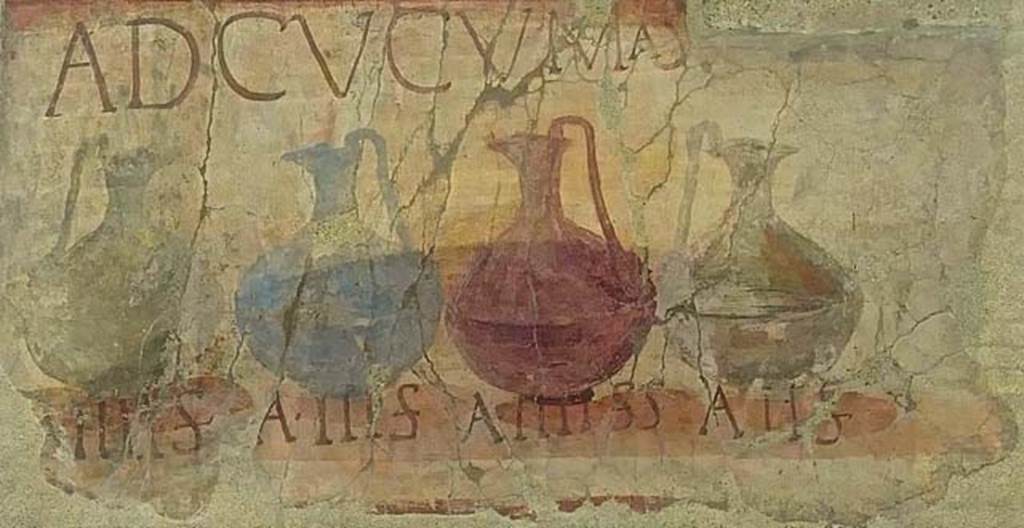 VI.13/14 Herculaneum, June 2017.  Enhanced part of the shop sign showing four jugs of different colours, naming and pricing the drinks sold here together with the shop sign AD CVCVMAS (Ad Cucumas), written above the jugs. Photo courtesy of Michael Binns.
