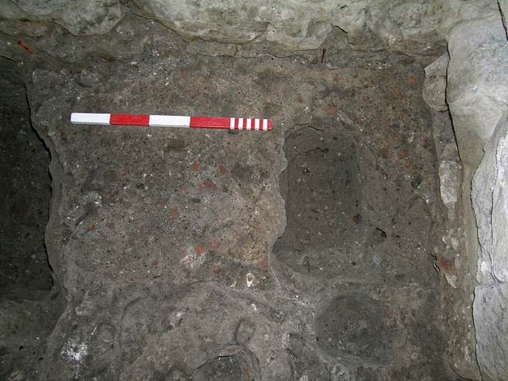 VI.15, Herculaneum. September 2005. Detail from near east wall of shop-room, with base of stairs, on right. 
Photo courtesy of Nicolas Monteix.
