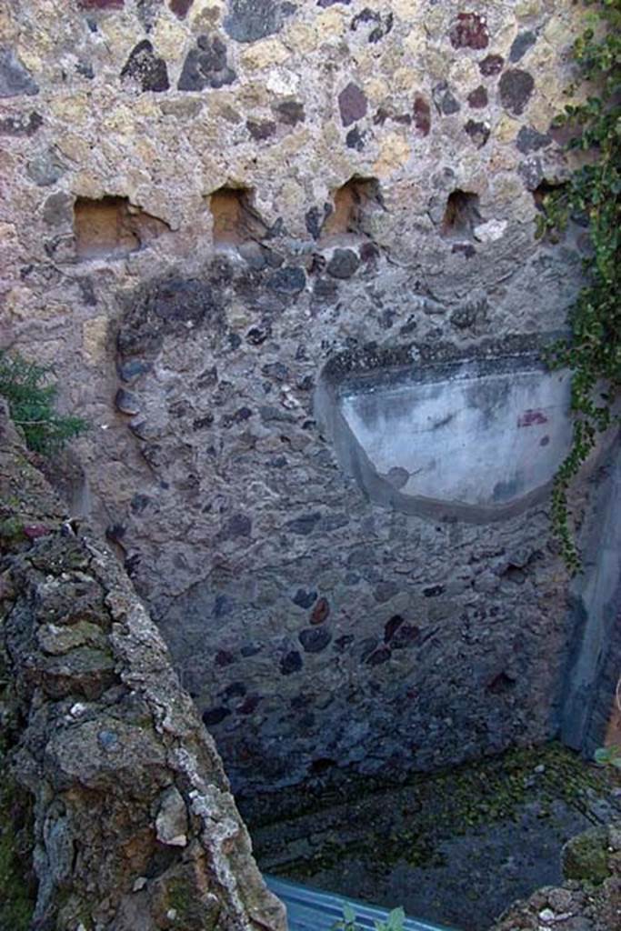 VI.17, Herculanium. February 2003. 
Looking towards south wall, with holes for support beams for an upper floor.
Photo courtesy of Nicolas Monteix.
