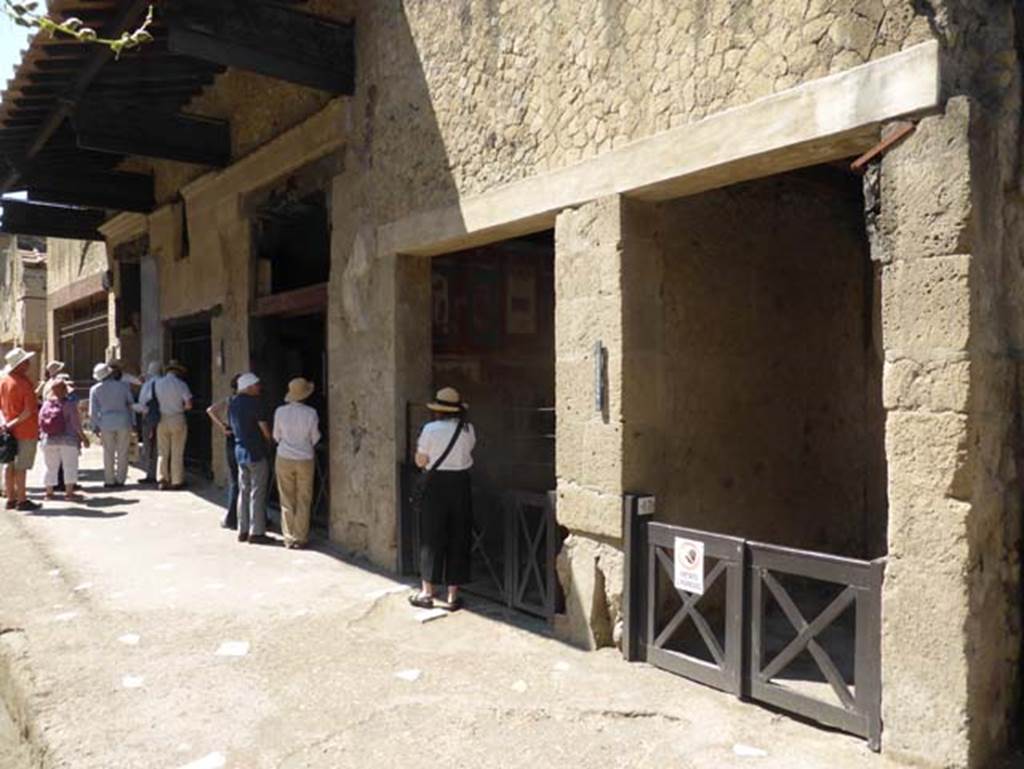 VI.17 Herculaneum, on right. June 2014. Looking east along south side of Decumanus Maximus.  Photo courtesy of Michael Binns.
