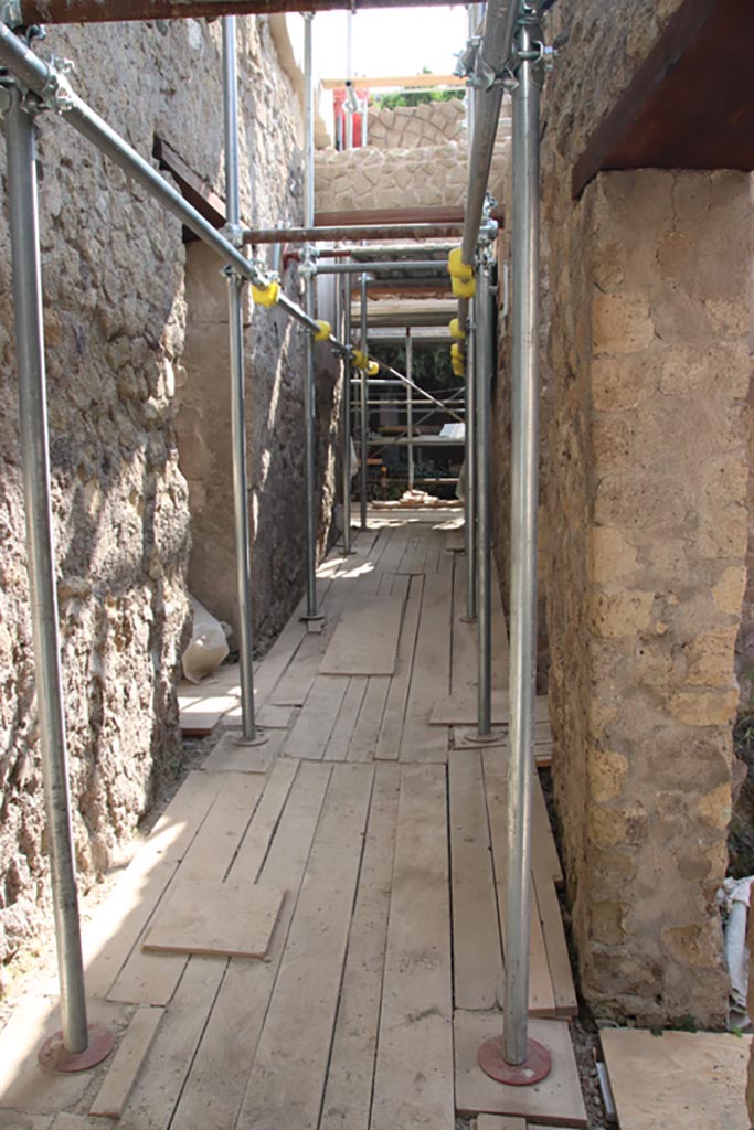 VI.26 Herculaneum, October 2023. 
Looking east along corridor leading to peristyle, under renovation. Photo courtesy of Klaus Heese.
